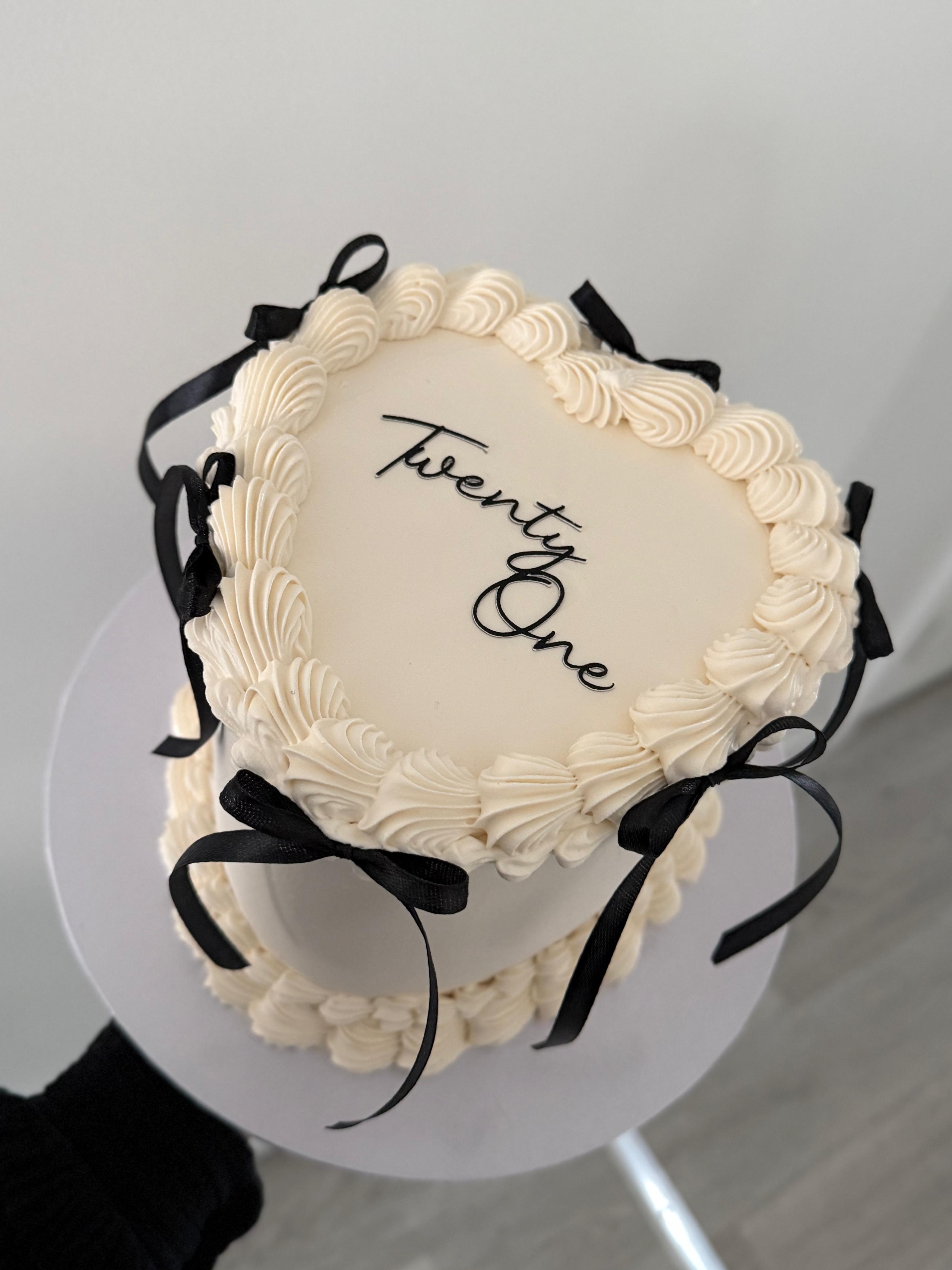 Pastel birthday cake with whimsical piping and lettering